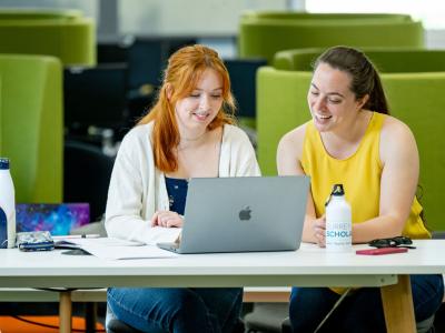 Postgraduate students studying in the library