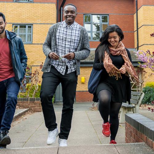 Three students outside halls on campus