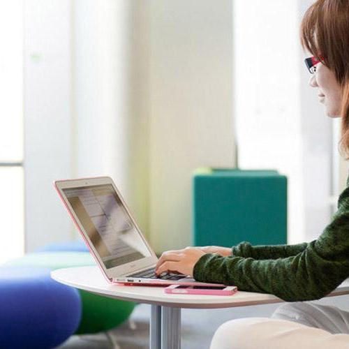 Student sat in the Library on her laptop