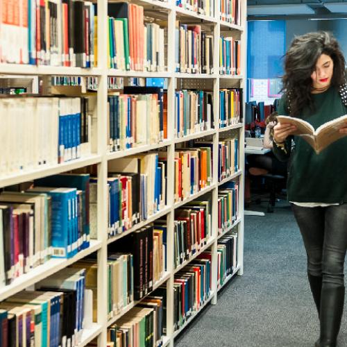 Student walking through library